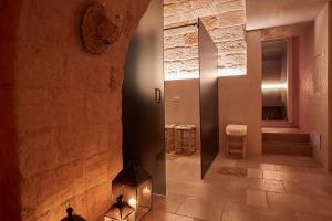a hallway with a stone wall and a fireplace at Musae Relais & SPA in Polignano a Mare