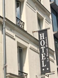a hotel sign on the side of a building at Le Saint Hubert - Adriatic Hotel in Paris