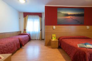 Postel nebo postele na pokoji v ubytování Hotel Angelo + 11 fotografií