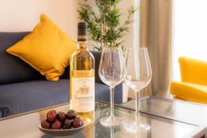 a bottle of wine sitting on a table with two wine glasses at Royal Arts-Loi Studio in Brussels +4 photos