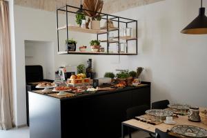 a kitchen with a counter with food on it at Musae Relais & SPA in Polignano a Mare