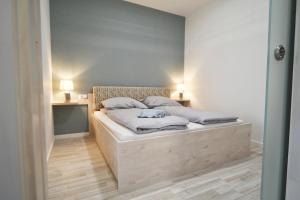 A bed or beds in a room at Moment Apartments