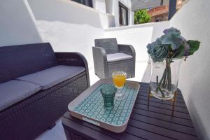 a coffee table with a glass of orange juice on it at Letmalaga Carlos Haya in Málaga