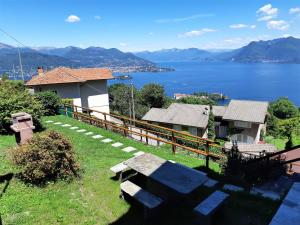 a house with a view of the water at Le Camere Della Vecchia Osteria in Stresa