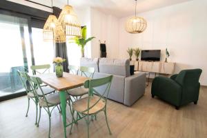 a living room with a table and chairs and a couch at Letmalaga Carlos Haya in Málaga