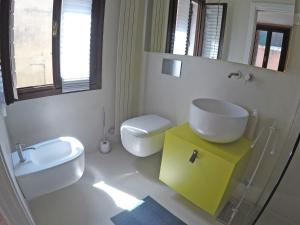 a bathroom with a sink and a toilet and a mirror at San Polo Family Apartment in Venice