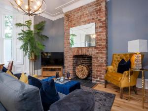 a living room with a couch and a fireplace at Bootham Luxury Apartments in York