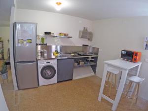 a kitchen with a refrigerator and a washing machine at San Polo Family Apartment in Venice