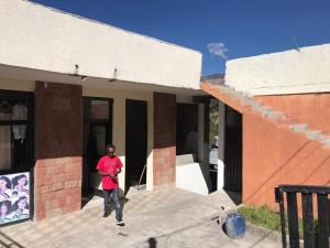a man is standing outside of a house at Amazing Lalibela Home stay in Lalibela