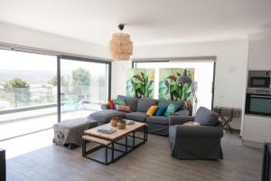 a living room with a couch and a table at Cairnvillas - Le Maquis C34 Luxury Villa with Private Pool near Beach in Aljezur
