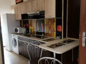 a kitchen with a sink and a stove and a microwave at Pokoje Gościnne-Kwatera u Evy in Swarzewo