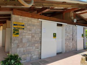 a group of three garage doors on a building at Campeggio Gianna Golfo dei Poeti in Lerici
