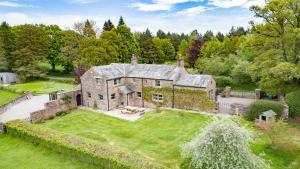 an aerial view of a large stone house with a yard at Rose Cottage in Sandford