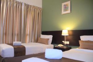 Postel nebo postele na pokoji v ubytování Alami Garden Hotel