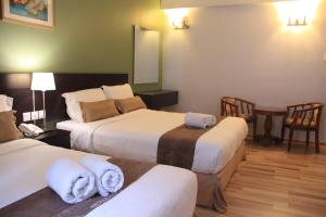 Postel nebo postele na pokoji v ubytování Alami Garden Hotel