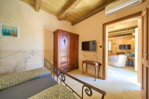 a bedroom with two beds and a television in a room at Villa Stone Queen in Malinska