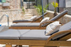 a row of chairs with pillows on them at Villa Stone Queen in Malinska +30 photos