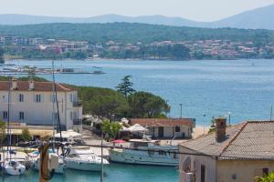 a group of boats are docked in a harbor at Villa Stone Queen in Malinska