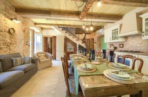 a kitchen and living room with a table and a couch at Villa Stone Queen in Malinska