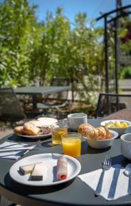 a table with plates of food and drinks on it at ibis budget Brignoles Provence in Brignoles