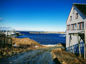 una casa y un camino junto a un cuerpo de agua en HI-Bonavista Hostel, en Bonavista