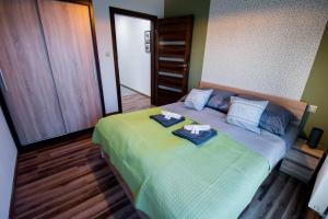 a bedroom with a bed with two towels on it at Apartament Kustronia z Garażem in Bielsko-Biala +23 photos