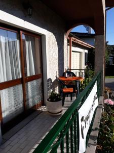 a porch of a house with a wooden door and a table at Cynda´s home in Viseu