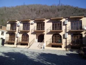 a building with balconies on the side of it at Inn Rif in Gagra