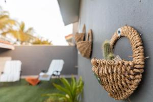 a wicker basket hanging on the side of a wall at La Casita Torres in Oranjestad