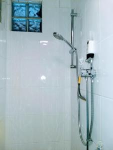 a bathroom with a shower with a shower head at Quiet comfortable Patcham studio Free parking Hallway shared with host in Brighton & Hove
