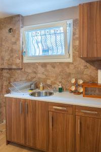 a kitchen with a sink and a window at Starfish Villa in Iraklitsa +87 photos