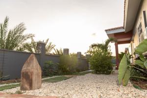 a rock in a yard next to a house at La Casita Torres in Oranjestad