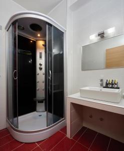 a bathroom with a shower and a sink at Altamar Hotel in Pefki