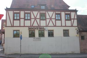 a building with a sign on the front of it at Hotel Zur Friedenslinde in Nuremberg