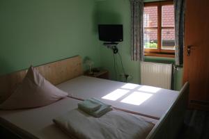 a bed with two towels on it in a bedroom at Hotel Zur Friedenslinde in Nürnberg