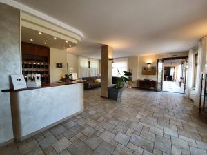 a lobby of a hotel with a counter and a room at Hotel Le Colline in San Gimignano