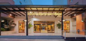 a store entrance with a sign that reads hollywood american music at H10 Mediterranean Village in Salou