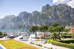 a view of a harbor with mountains in the background at Residence Centro Vela in Riva del Garda