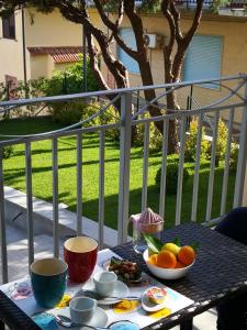 a table with bowls of fruit on a balcony at Residence VILLA FIORITA in Roccella Ionica