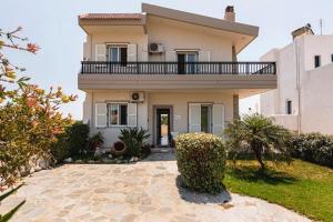 a large house with a balcony on top of it at Gennadi Villa Del Mar in Gennadi