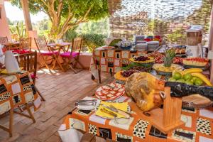 a table full of food on a patio at Inn Seventies Cheap and Chic in Lagos