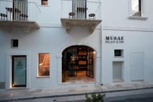a white building with a entrance to a store at Musae Relais & SPA in Polignano a Mare