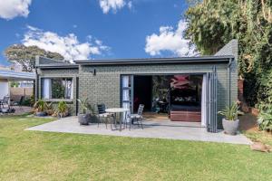 a house with a patio with a table and chairs at The Hideaway in Benoni