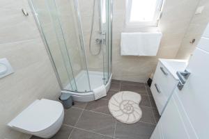 a bathroom with a shower and a toilet and a sink at LUXURY APARTMENTS - LA VIR 1 & 2 in Vir +50 photos