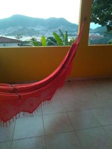 a red hammock in a room with a view at Alto do Marinas in Angra dos Reis
