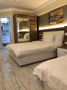 Postel nebo postele na pokoji v ubytování ANKARA ATLANTİK OTEL