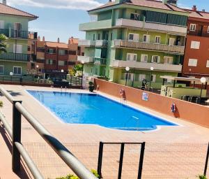 a swimming pool on the side of a building at ALMA Elegant Suite Apartment in Candelaria