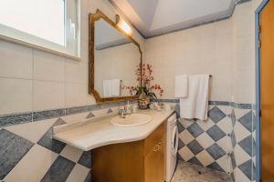 a bathroom with a sink and a mirror at Gennadi Villa Del Mar in Gennadi +25 photos