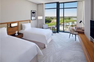 Postel nebo postele na pokoji v ubytování Vida Emirates Hills