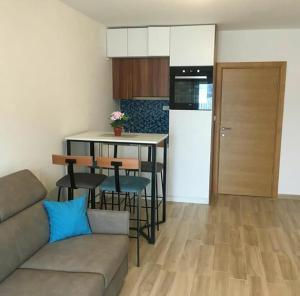 a living room with a couch and a kitchen at Apartman Matija in Herceg-Novi +6 photos